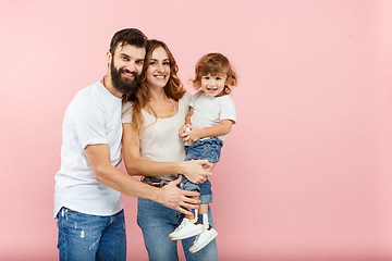 Image showing A happy family on pink background