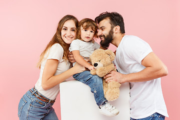 Image showing A happy family on pink background