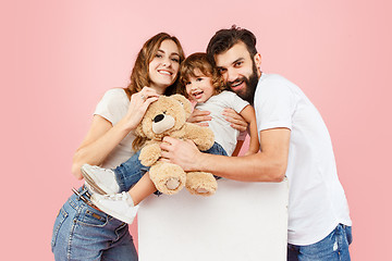 Image showing A happy family on pink background