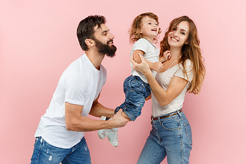 Image showing A happy family on pink background