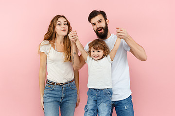 Image showing A happy family on pink background