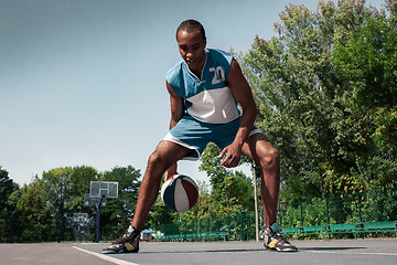 Image showing Picture of young confused african basketball player practicing