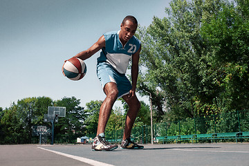 Image showing Picture of young confused african basketball player practicing