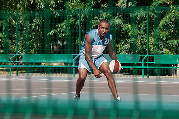 Image showing Picture of young confused african basketball player practicing