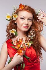 Image showing Portrait of beautiful woman with spring flowers 