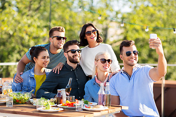 Image showing happy friends taking selfie at rooftop party