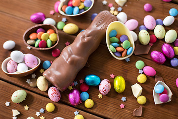 Image showing chocolate eggs, easter bunny and candies on wood