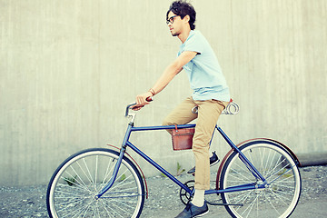 Image showing young hipster man riding fixed gear bike