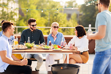 Image showing happy friends having bbq party on rooftop