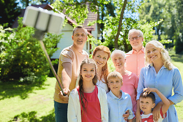 Image showing happy family taking selfie in summer garden