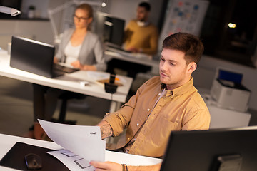 Image showing designer or software developer at night office