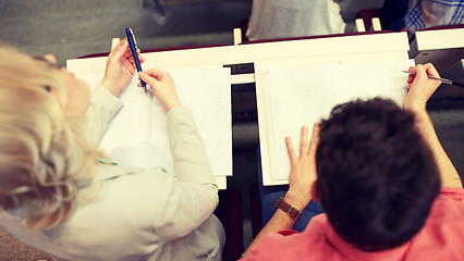 Image showing students with notebooks at exam or lecture