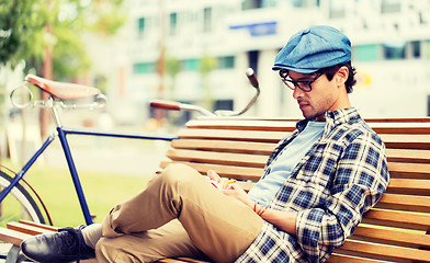 Image showing man with notebook or diary writing on city street