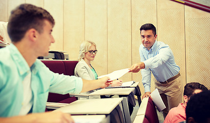 Image showing teacher giving tests to students at lecture