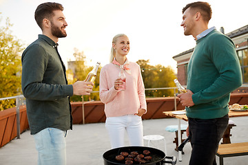 Image showing happy friends having bbq party on rooftop