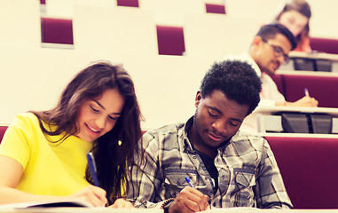 Image showing group of students with notebooks in lecture hall