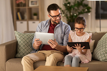 Image showing father and daughter with tablet computers at home