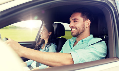 Image showing happy man and woman driving in car