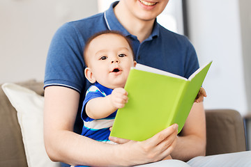 Image showing happy father and little baby son with book at home