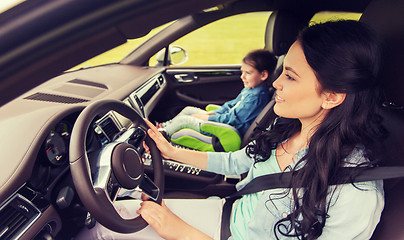 Image showing happy woman with little child driving in car