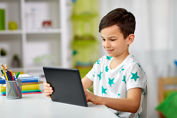 Image showing student boy with tablet pc and notebook at home