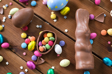 Image showing chocolate eggs, easter bunny and candies on wood