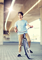 Image showing young hipster man riding fixed gear bike