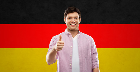 Image showing happy man showing thumbs up over german flag