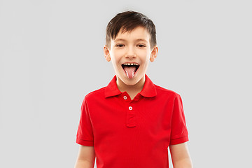 Image showing boy in red polo t-shirt showing his tongue