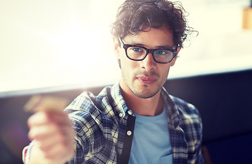 Image showing happy man paying with credit card at cafe