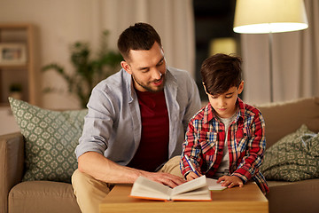 Image showing father and son doing homework together