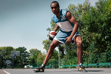 Image showing Picture of young confused african basketball player practicing