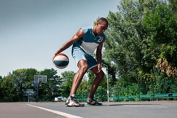Image showing Picture of young confused african basketball player practicing