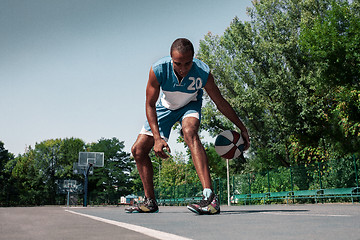 Image showing Picture of young confused african basketball player practicing