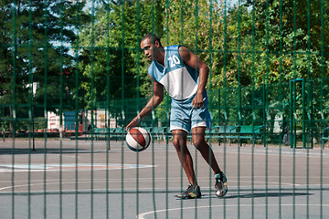 Image showing Picture of young confused african basketball player practicing