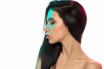 Image showing High Fashion model woman in colorful bright lights posing in studio