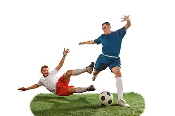 Image showing Football players tackling for the ball over white background