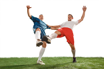 Image showing Football players tackling for the ball over white background