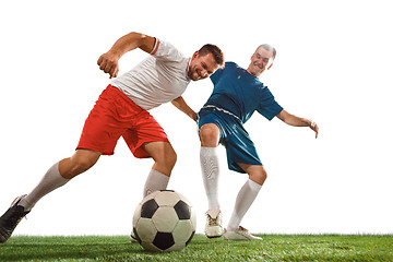 Image showing Football players tackling for the ball over white background