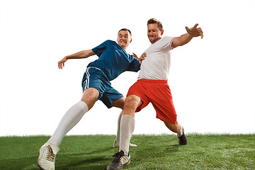 Image showing Football players tackling for the ball over white background