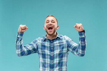 Image showing Winning success man happy ecstatic celebrating being a winner. Dynamic energetic image of male model