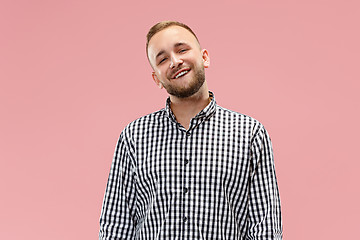 Image showing The happy business man standing and smiling against pink background.