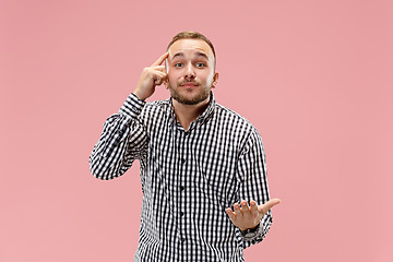 Image showing Beautiful male half-length portrait isolated on pink studio backgroud.