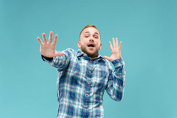 Image showing Portrait of the scared man on blue