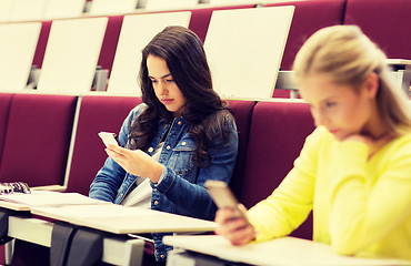 Image showing student girls with smartphones on lecture