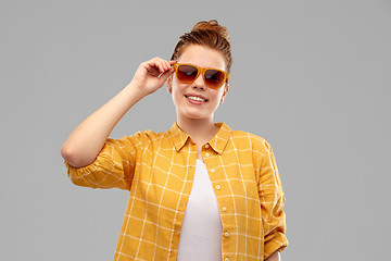 Image showing smiling red haired teenage girl in sunglasses