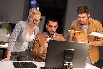 Image showing business team with computer working late at office