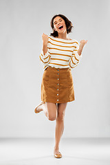 Image showing young woman in striped pullover, skirt and shoes