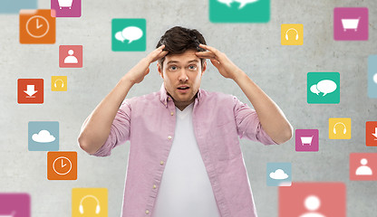 Image showing man touching his head over app icons on grey
