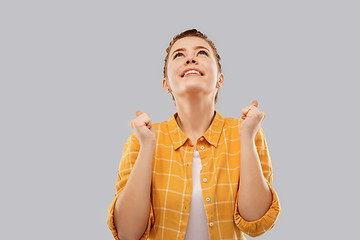 Image showing happy red haired teenage girl celebrating success